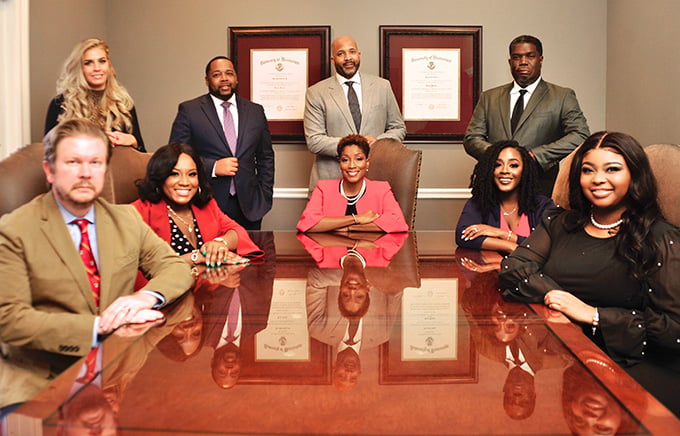 Photo of the attorneys and staff around a conference table.